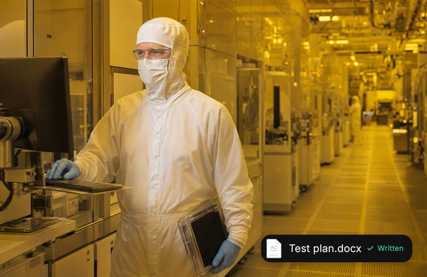 Erik, a process engineer in a full cleanroom suit, at a fab terminal under amber lithography light; a test plan, written.