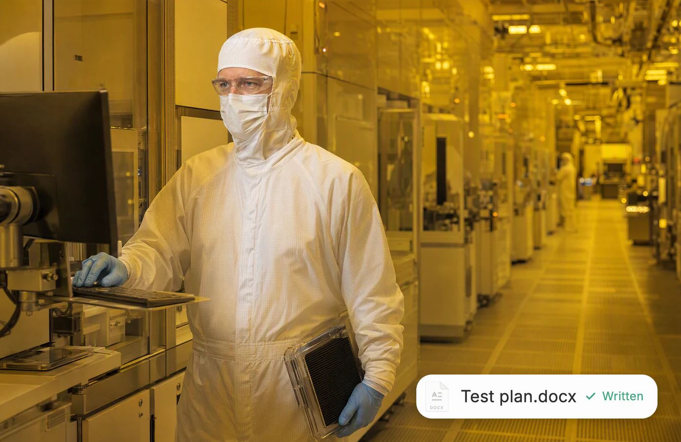 Erik, a process engineer in a full cleanroom suit, at a fab terminal under amber lithography light; a test plan, written.