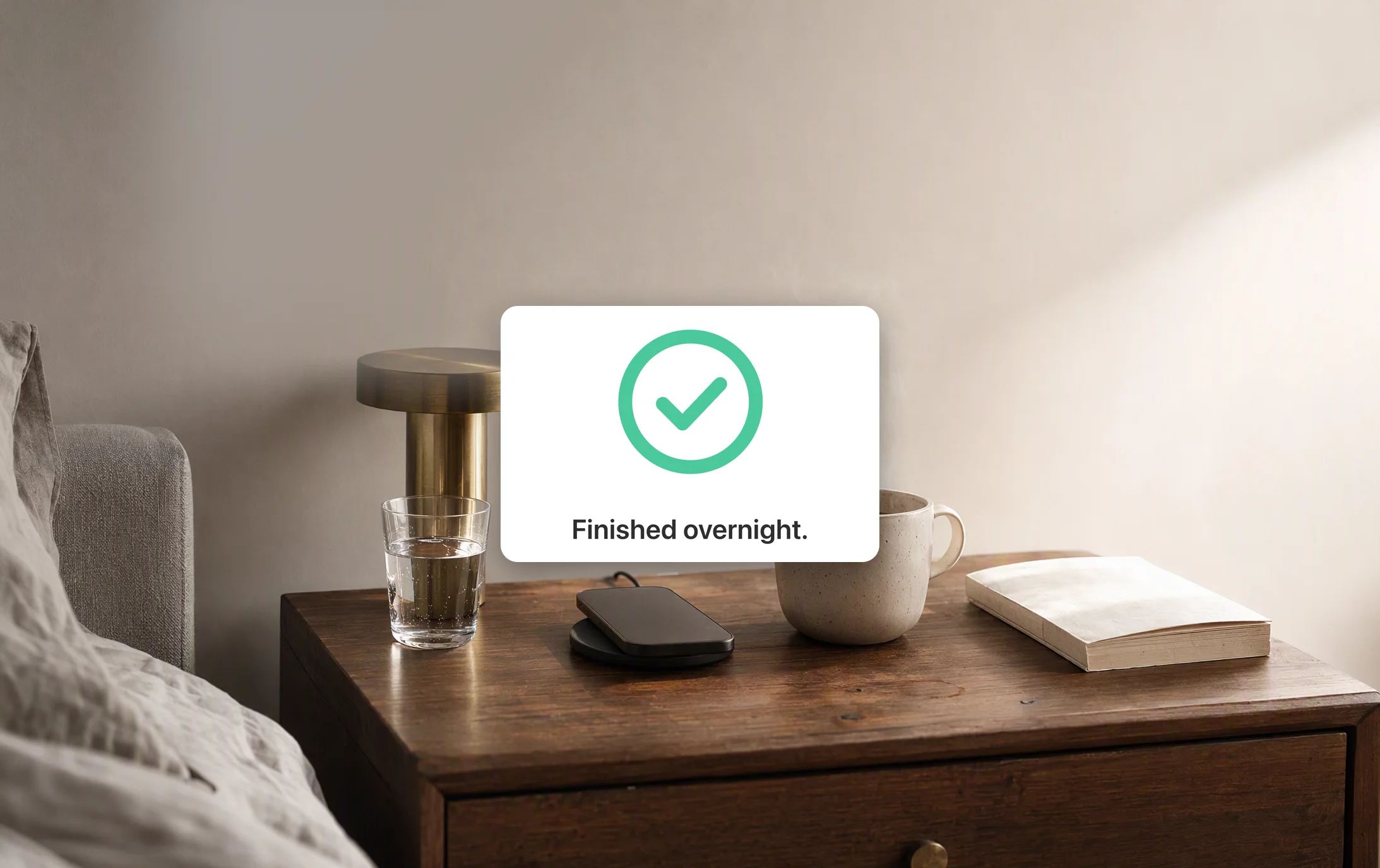 A nightstand in the morning, the lamp off, coffee steaming and the phone on its charger, and Dvina's card, a checked ring: “Finished overnight.”