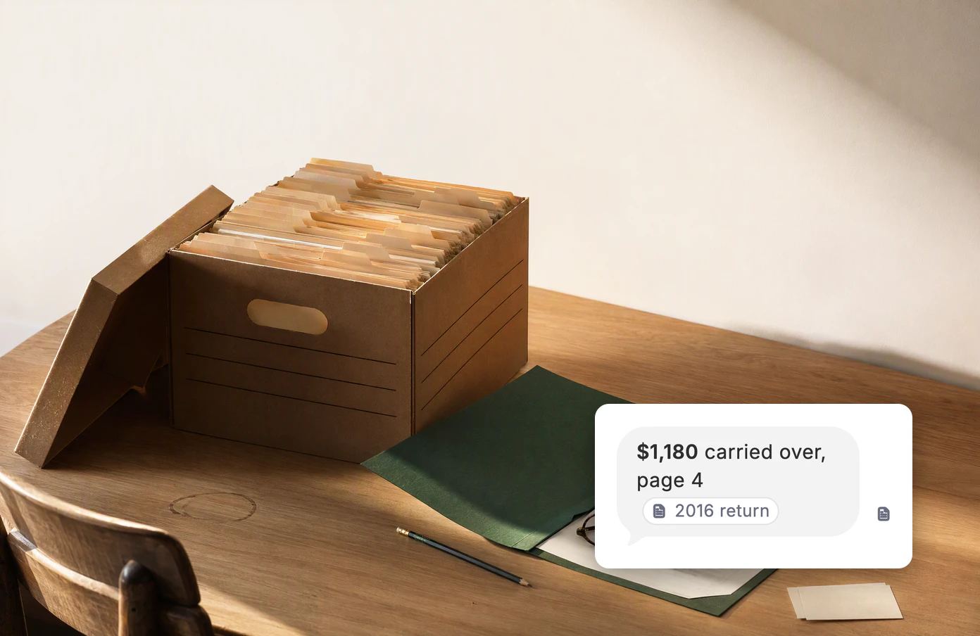 A banker’s box of old tax folders on a desk, one folder open. Dvina’s answer: $1,180 carried over, page 4, citing the 2016 return.