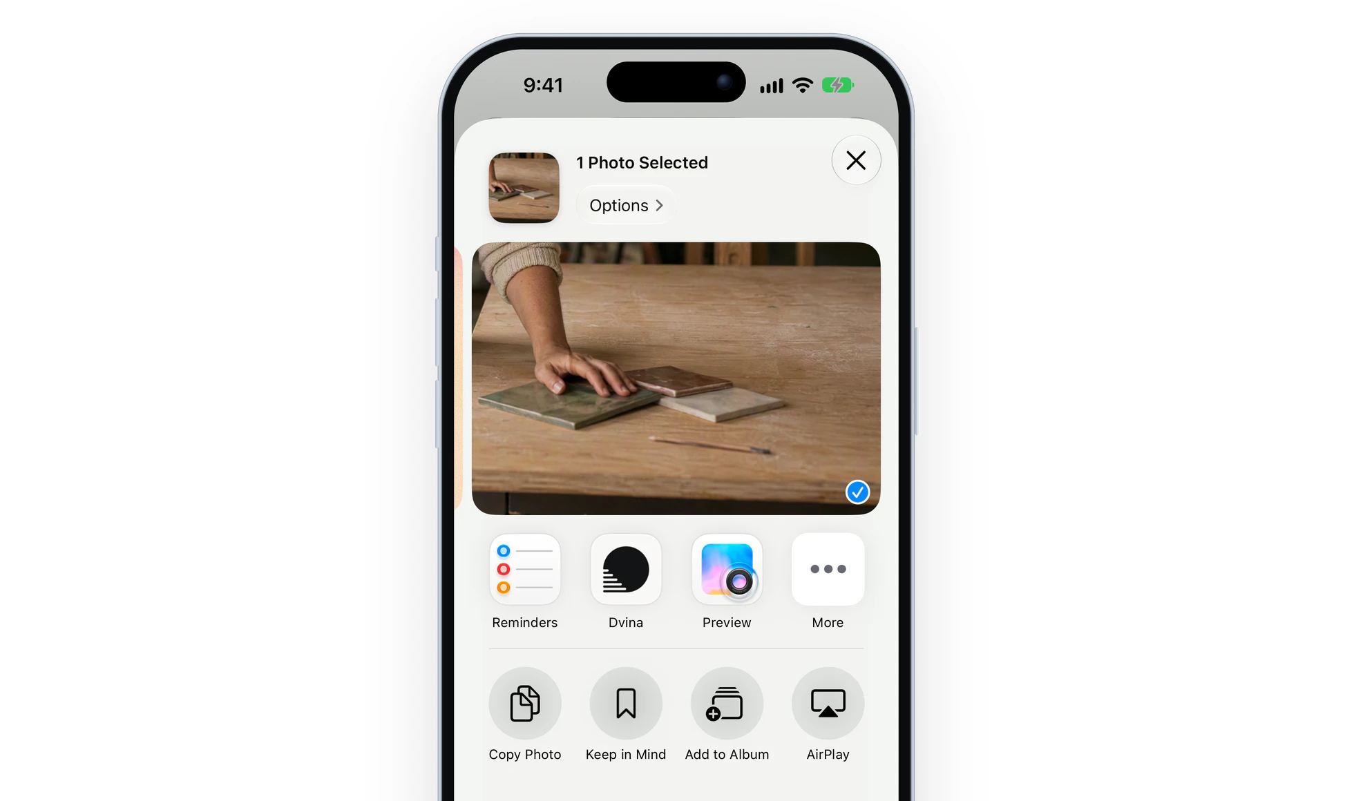 The share sheet on an iPhone over a photo of kitchen tile samples, with Keep in Mind under Dvina.