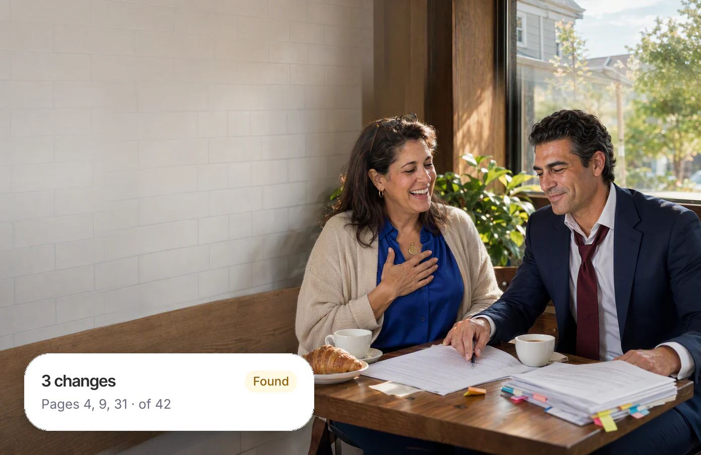 A lawyer at a café table taps his pen on page 9 of his client’s printed lease, and she laughs with relief; his Dvina card: three changes, on pages 4, 9 and 31 of 42.